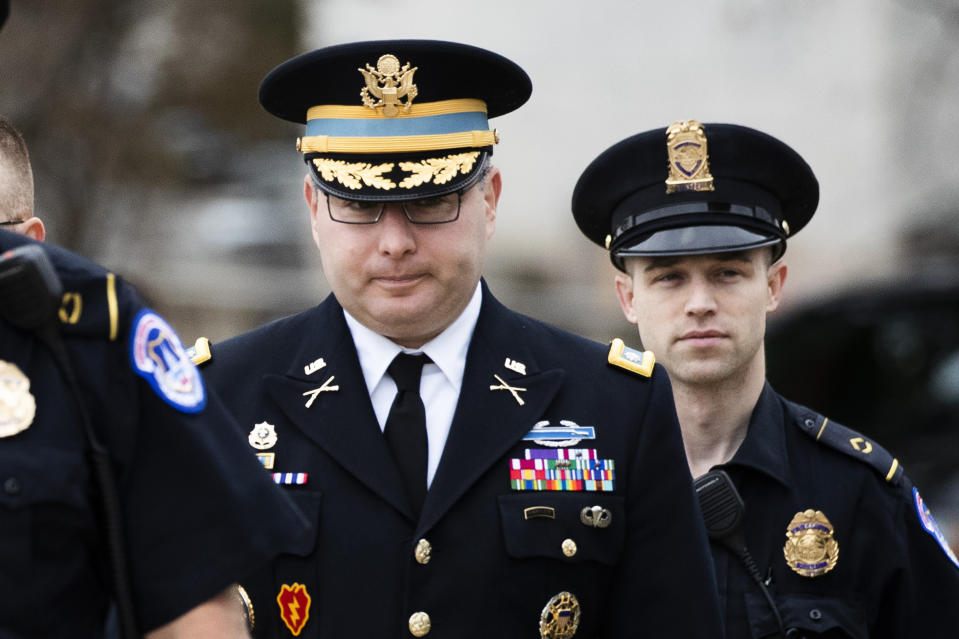 Army Lieutenant Colonel Alexander Vindman, a military officer at the National Security Council, center, arrives on Capitol Hill in Washington, Tuesday, Oct. 29, 2019, to appear before a House Committee on Foreign Affairs, Permanent Select Committee on Intelligence, and Committee on Oversight and Reform joint interview with the transcript to be part of the impeachment inquiry into President Donald Trump. (AP Photo/Manuel Balce Ceneta)