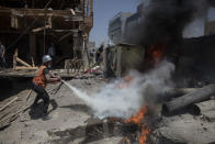 A Palestinian firefighter extinguishes a fire from a beachside cafe after it was hit by an Israeli airstrike, in Gaza City, Monday, May 17, 2021. (AP Photo/Khalil Hamra)