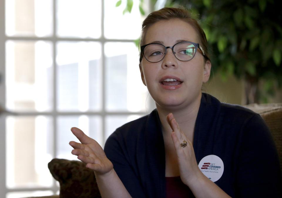 In this March 10, 2014 photo, Samantha Gongora, a field organizer with Enroll America, talks about enrollment efforts in the Houston area during an Affordable Care Act enrollment event in Houston. (AP Photo/David J. Phillip)