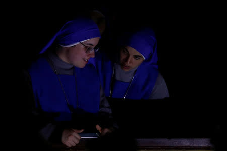 Nuns await the Easter vigil Mass led by Pope Francis in Saint Peter's Basilica at the Vatican, April 20, 2019. REUTERS/Remo Casilli