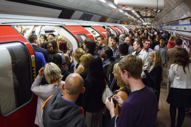 Commuters queuing for Tube trains at Green Park Tube Station