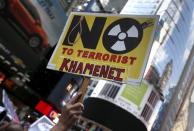 A protestor holds a placard during a demonstration and rally apposing the nuclear deal with Iran in Times Square in the Manhattan borough of New York City, July 22, 2015. REUTERS/Mike Segar