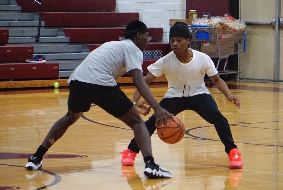 Two kids play basketball Saturday, May 4, at a fundraiser organized by West High students to address gun violence.