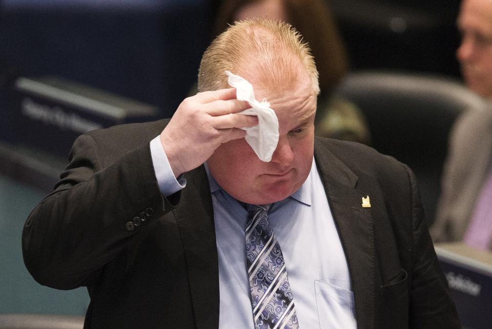 Toronto Mayor Rob Ford wipes his face during council at City Hall in Toronto