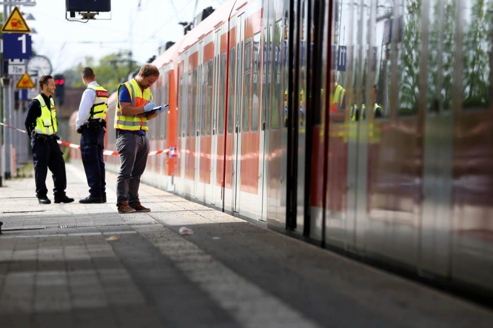 Police investigate the scene of a stabbing at a station in Grafing near Munich, Germany, Tuesday, May 10, 2016. (AP Photo/Matthias Schrader)