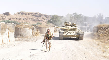 A tank is pictured as Iraqi security forces patrol after clashes with militants of the Islamic State, formerly known as the Islamic State in Iraq and the Levant (ISIL), in the Hamrin mountains in Diyala province July 16, 2014. REUTERS/Stringer