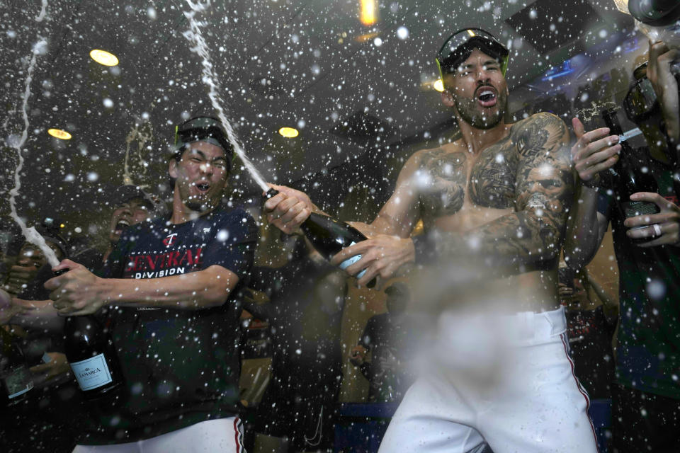 El japonés Kenta Maeda y el puertorriqueño Carlos Correa, de los Mellizos de Minnesota, festejan la conquista del cetro de la División Central de la Liga Americana, tras una victoria ante los Angelinos de Los Ángeles, el viernes 22 de septiembre de 2023 (AP Foto/Abbie Parr)