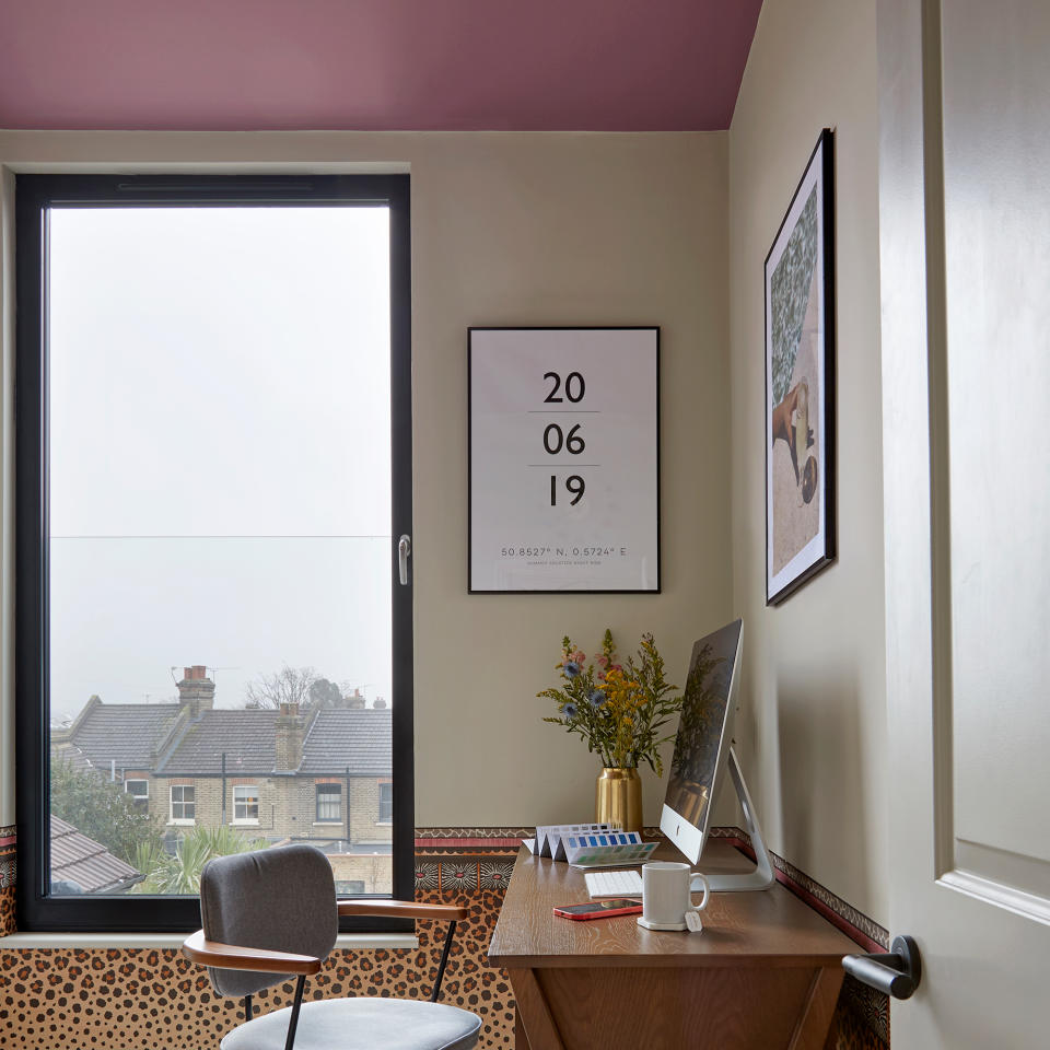 Cream home office with pink ceiling and leopard print border