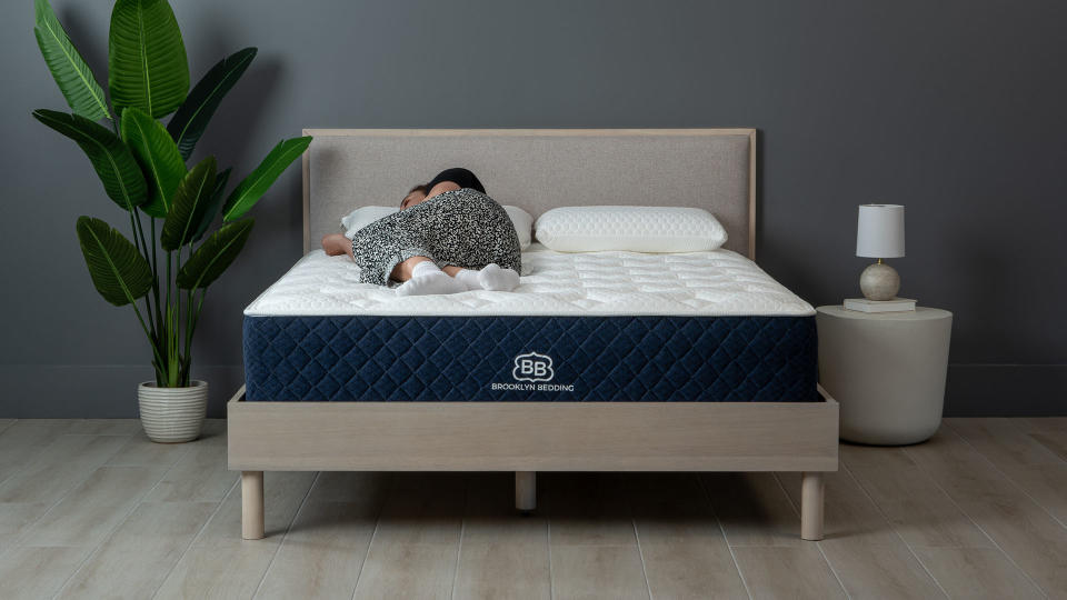 Brooklyn Bedding Signature Hybrid mattress with a woman side-sleeping on it