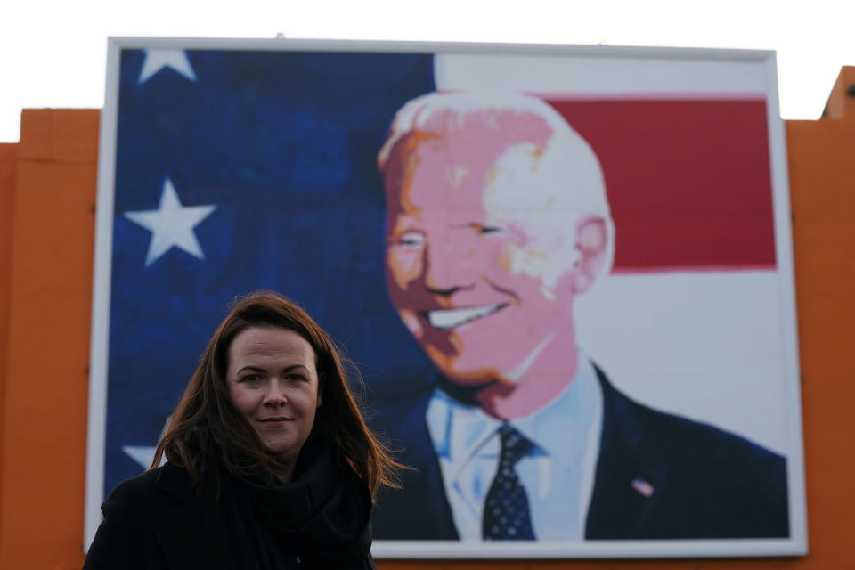 Image: Laurita Blewitt, who is a cousin of Democratic U.S. presidential nominee Joe Biden, poses in front of a Biden mural erected for the U.S. elections in the ancestral home of the Biden's in Ballina (Clodagh Kilcoyne / Reuters)