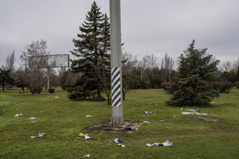 The remains of a Russian billboard are scattered on the grass at an intersection in Kherson, southern Ukraine, Sunday, Nov. 27, 2022. (AP Photo/Bernat Armangue)