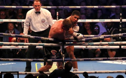 Anthony Joshua sends Alexander Povetkin into the ropes - Credit: reuters