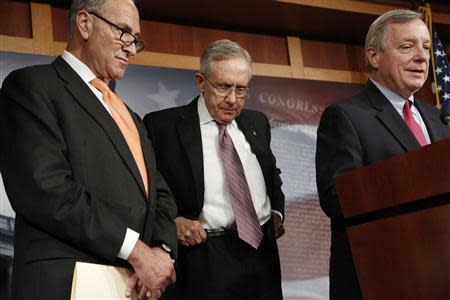 U.S. Senate Majority Leader Harry Reid (D-NV) (C) hitches up his belt during a news conference with Senator Charles Schumer (D-NY) (L) and Senator Richard Durbin (D-IL) at the U.S. Capitol in Washington, October 2, 2013. REUTERS/Jonathan Ernst