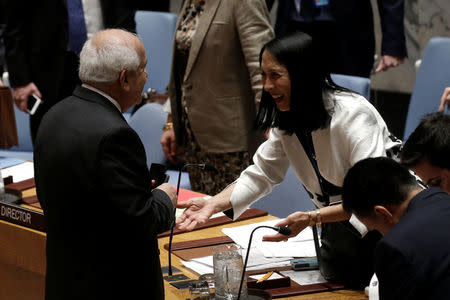 Palestinian Ambassador to the United Nations Riyad Mansour (L) greets Michele Sison, U.S. Deputy Ambassador to the United Nations, before a U.N. Security Council meeting on the situation in the Middle East at U.N. headquarters in New York City, New York, U.S., March 24, 2017. REUTERS/Mike Segar