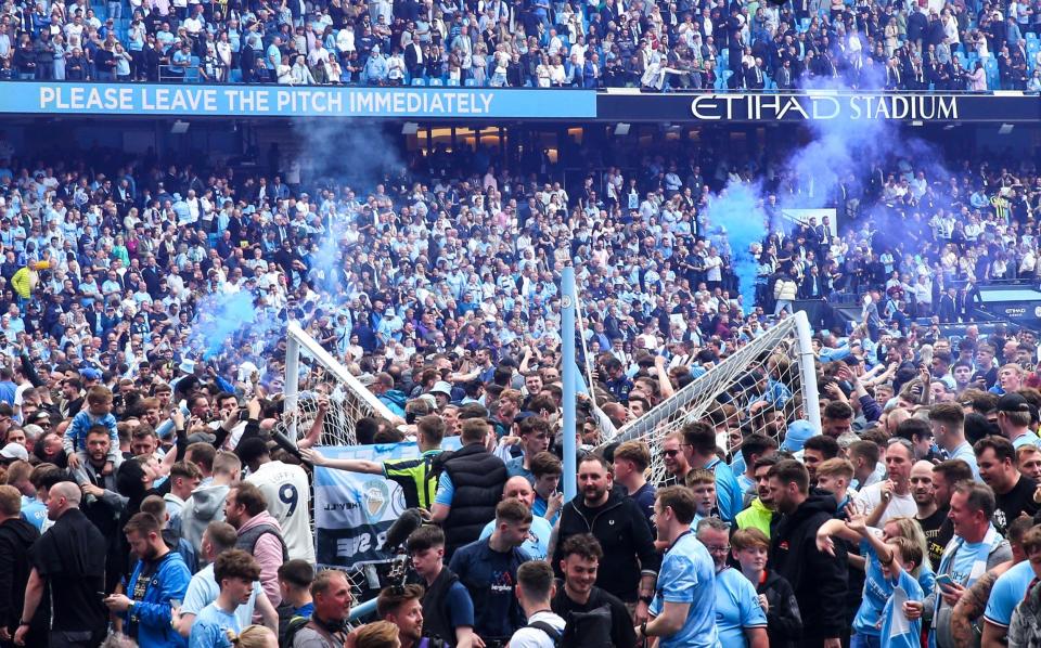 Man City fans invaded the pitch after their dramatic title-clinching win. - GETTY IMAGES