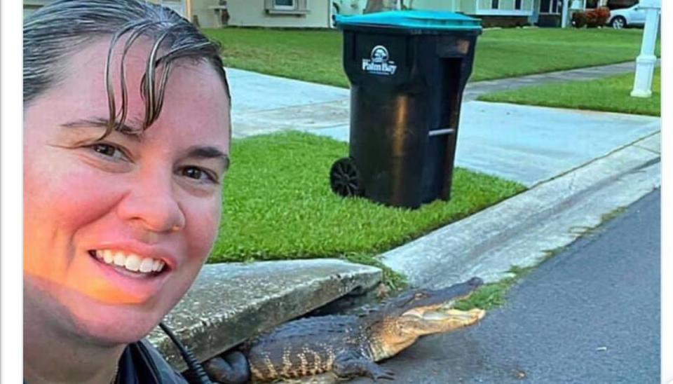 Palm Bay Police Department cop poses with gator