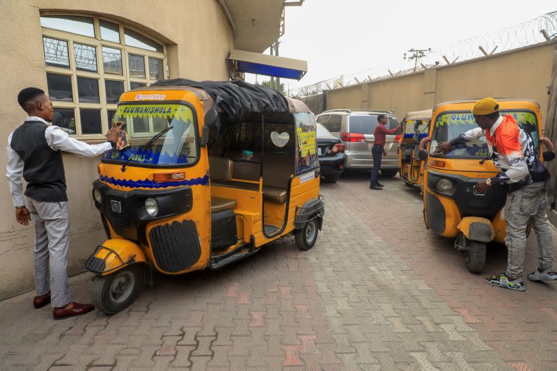 Corporate tricycle riders clean their tricycles popularly known as 'keke' in Lagos