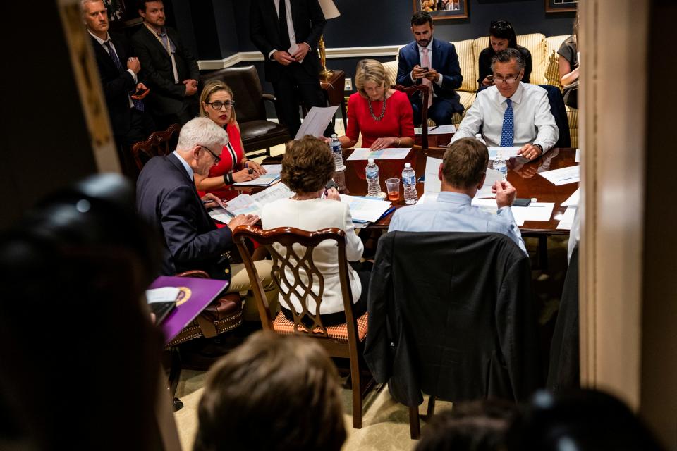 Sens. Bill Cassidy, R-La., Kyrsten Sinema, D-Ariz., Lisa Murkowski, R-Alaska, and Mitt Romney, R-Utah, hold a bipartisan meeting on infrastructure in the basement of the U.S. Capitol building after original talks fell through with the White House on June 8.