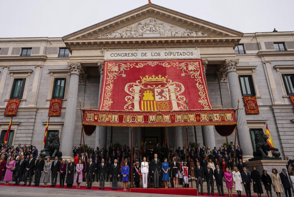 Princess Leonor, center, next to Spanish King Felipe VI, Queen Letizia and her sister Sofia, right, attend a military parade under the "baldachin," or canopy, after swearing allegiance to the Constitution during a gala event that makes her eligible to be queen one day, in Madrid on Tuesday, Oct. 31 2023. Since its foundation in 1721, the Royal Tapestry Factory of Madrid has not stopped producing. It was Philip V, then King of Spain, who had the factory built with the help of Catholic craftsmen from Flanders to replace the lack of private initiative that existed at the time. (AP Photo/Manu Fernandez)