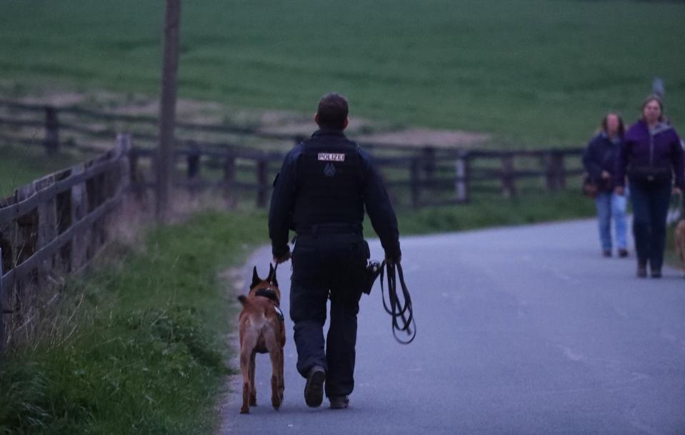 <p>A police dog handler near the Borussia Dortmund team hotel after an explosion before the game Reuters / Kai Pfaffenbach Livepic </p>