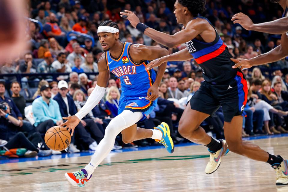 Thunder guard Shai Gilgeous-Alexander (2) works past Pistons guard Killian Hayes (7) in the third quarter of OKC's 124-112 win Monday night at Paycom Center.