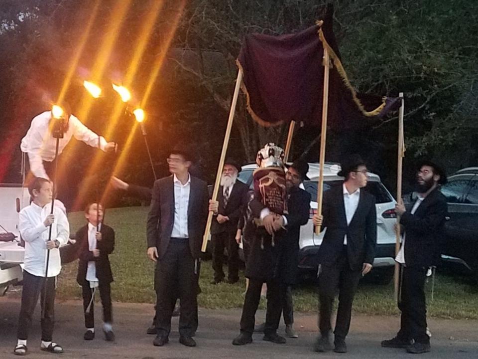 The new Torah is carried beneath a chuppa, a bouncing cloth canopy, to its new home at Chabad of Tallahassee on Tuesday, Oct. 10, 2023.
