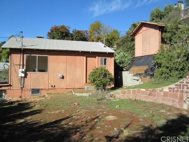 BEFORE: “We took out 35 dumpsters’ worth of soil just to build the retaining wall between the main house and the cabin,” Grey says. “There was supposed to be one there, but the original owners never finished it, so land was literally falling on top of the house. We had to get that permitted before anything else.”