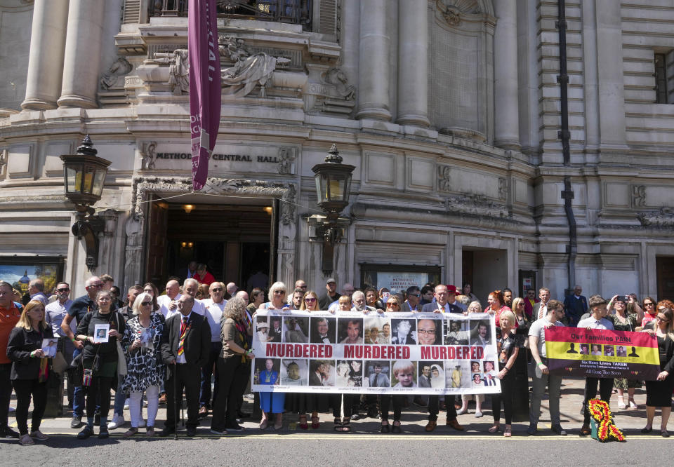 People carry pictures of relatives as they gather outside Central Hall in Westminster in London, after the publication of the Infected Blood Inquiry report, Monday May 20, 2024. British authorities and the country's public health service knowingly exposed tens of thousands of patients to deadly infections through contaminated blood and blood products, and hid the truth about the disaster for decades, an inquiry into the U.K.’s infected blood scandal found Monday. (Jeff Moore/PA via AP)