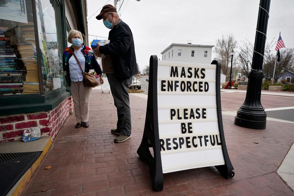 Shoppers comply with the mask regulations to help prevent the spread of the coronavirus at Bridgton Books Nov. 13, 2020, in Bridgton, Maine.