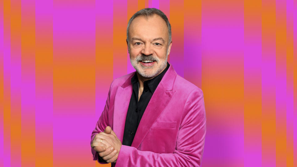 Graham Norton wearing a pink suit over a black shirt