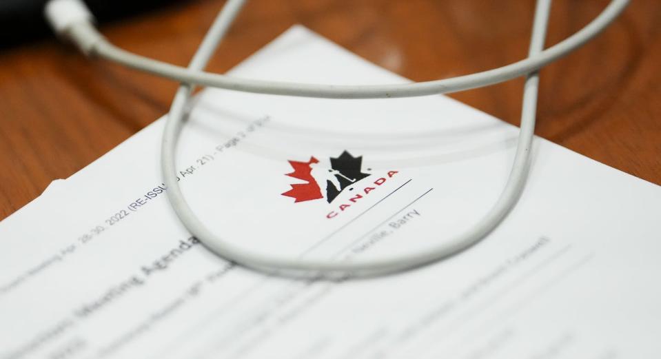 A Hockey Canada document is reviewed by a member of Parliament during a House of Commons committee hearing on safe sport. THE CANADIAN PRESS/Sean Kilpatrick