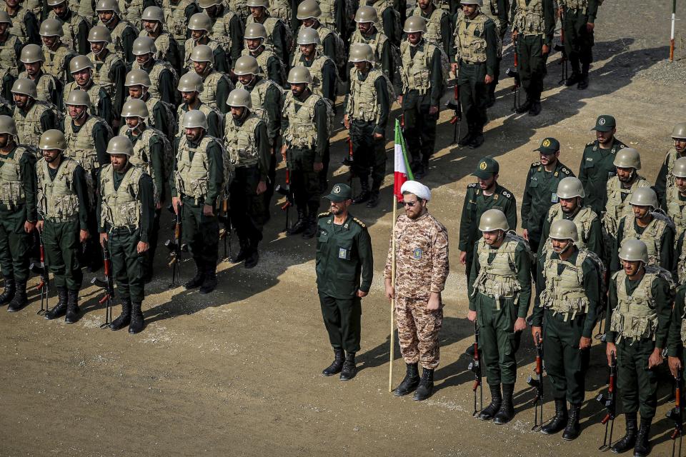 FILE - In this photo provided by the Revolutionary Guard's Ground Force Oct. 17, 2022, troops stand while attending a manoeuver in northwestern Iran. As protests rage at home, Iran's theocratic government is increasingly flexing its military muscle abroad. That includes supplying drones to Russia that now kill Ukrainian civilians, running drills in a border region with Azerbaijan and bombing Kurdish positions in Iraq. (Iranian Revolutionary Guard's Ground Force via AP, File)