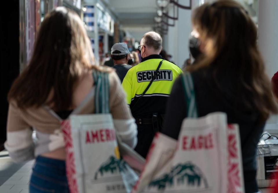 Arden Fair security officer David Thurber patrols the mall as customers shop in November 2021. California lawmakers have created a select committee to address retail theft.