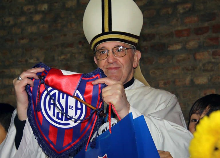 Argentina's cardinal Jorge Mario Bergoglio posing with the emblem of San Lorenzo's football team, which he supports in Buenos Aires, in an undated photo. Latin America's first pope, Jorge Mario Bergoglio of Argentina, combines conservative views with a common touch that endeared him to his parishioners in Buenos Aires, where he grew up as the son of working-class Italian immigrants