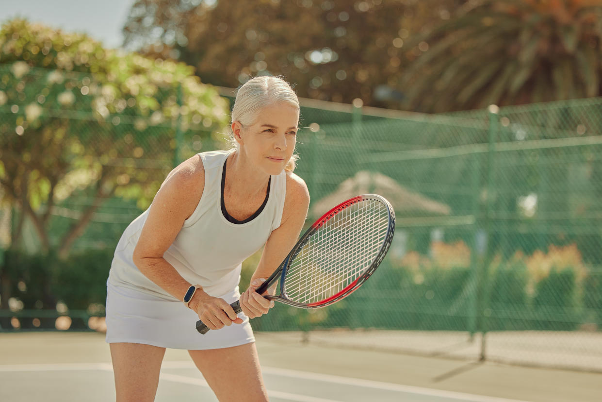 Sports, fitness and woman waiting in tennis, match and game on a court for retirement cardio. Exercise, practice and senior player in sport, training and learning for physical activity or hobby