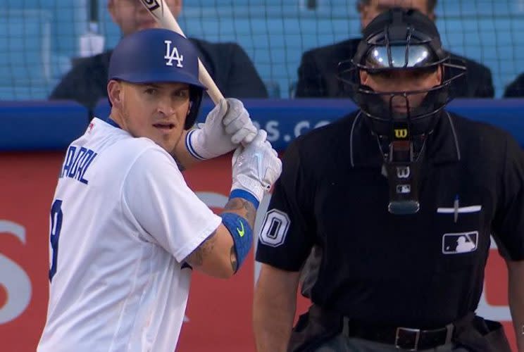 Dodgers switch hitter Yasmani Grandal awkwardly wears the wrong batting helmet during at-bat against the Cardinals. (MLB.TV)