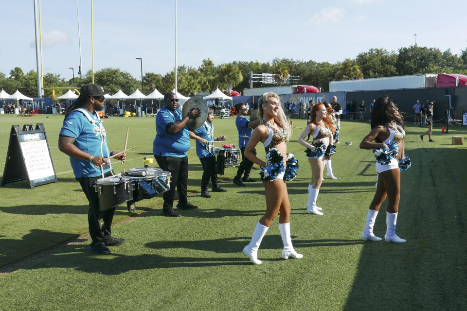 Jacksonville Jaguars cheerleaders perform for fans along with the team drum line during NFL football practice, Saturday, July 31, 2021, in Jacksonville, Fla. (AP Photo/John Raoux)