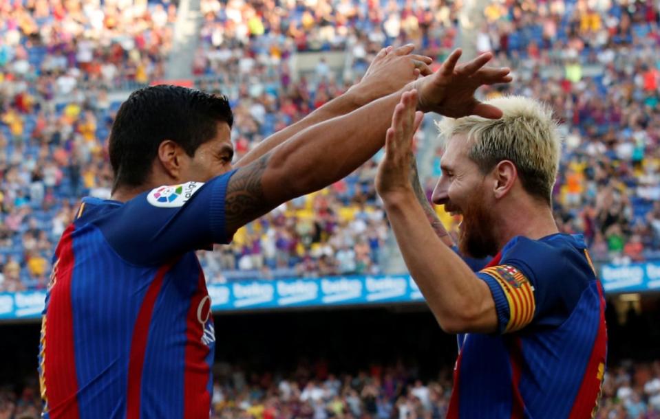 Luis Suarez (left) and Lionel Messi celebrate after scoring against Real Betis on Saturday. (Reuters)