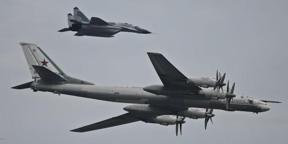 A Russian Tu-95 bear bomber and its escort fighter during an event in Russia.