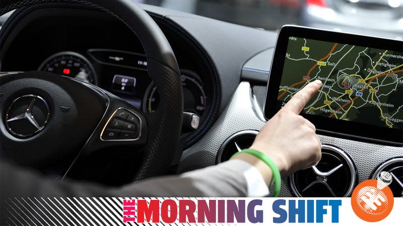 A Getty photo of a person using satellite navigation in a Mercedes-Benz in 2015, with the Jalopnik &quot;The Morning Shift&quot; banner over top.