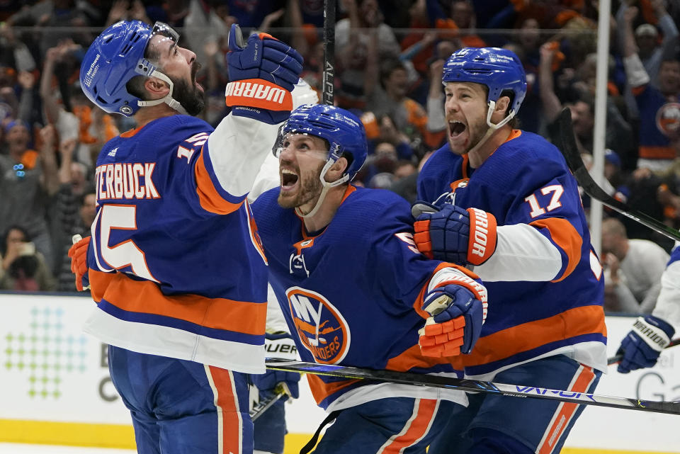 New York Islanders right wing Cal Clutterbuck (15) celebrates with teammates after scoring against the Tampa Bay Lightning during the second period of Game 3 of the NHL hockey Stanley Cup semifinals, Thursday, June 17, 2021, in Uniondale, N.Y. (AP Photo/Frank Franklin II)
