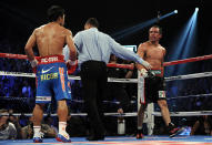 LAS VEGAS, NV - NOVEMBER 12: (L) Manny Pacquiao and Juan Manuel Marquez are seperated by referee Tony Weeks during the WBO world welterweight title fight at the MGM Grand Garden Arena on November 12, 2011 in Las Vegas, Nevada. (Photo by Harry How/Getty Images)