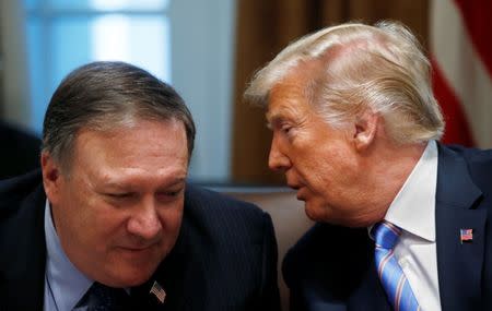 U.S. President Donald Trump whispers to Secretary of State Mike Pompeo during a cabinet meeting at the White House in Washington, U.S., July 18, 2018. REUTERS/Leah Millis