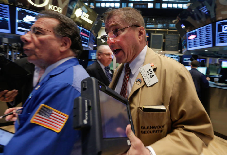 Trader David Williams, right, works on the floor of the New York Stock Exchange Tuesday, May 13, 2014. The Standard & Poor's 500 index crossed above 1,900 for the first time Tuesday as investors assessed news on retail sales. DirecTV gained on reports that the AT&T is poised to buy the company for nearly $50 billion. (AP Photo)