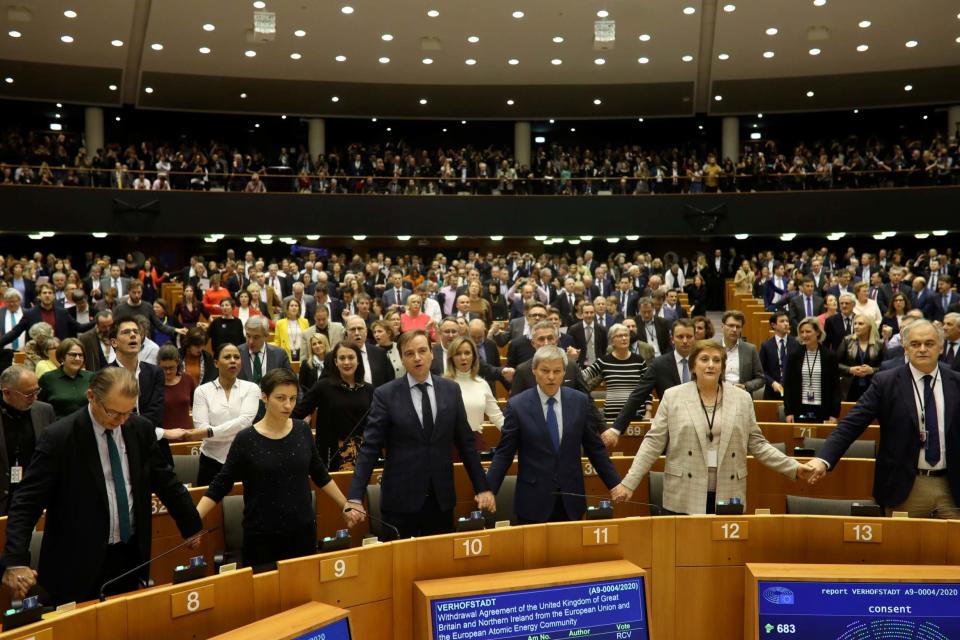 MEP's hold hands and sing after a vote on the UK's withdrawal from the EU (AP)