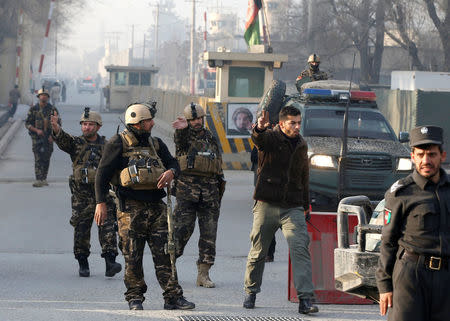 Afghan security forces keep watch at a check point close to the compound of Afghanistan's national intelligence agency in Kabul, Afghanistan. December 25, 2017. REUTERS/Omar Sobhani