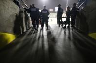 National Police and National Guards keep watch during the opening winter season game between Leones de Caracas and Tigres de Aragua in Caracas, Venezuela, Tuesday, Nov. 5, 2019. This season came at the end of a tumultuous year for Venezuelans and the nation's crisis has no end in sight. (AP Photo/Ariana Cubillos)