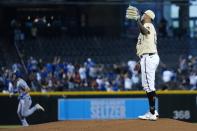 Arizona Diamondbacks starting pitcher Humberto Mejia, right, gets a new baseball after giving up a home run to Los Angeles Dodgers' Trea Turner, left, during the first inning of a baseball game Sunday, Sept. 26, 2021, in Phoenix. (AP Photo/Ross D. Franklin)