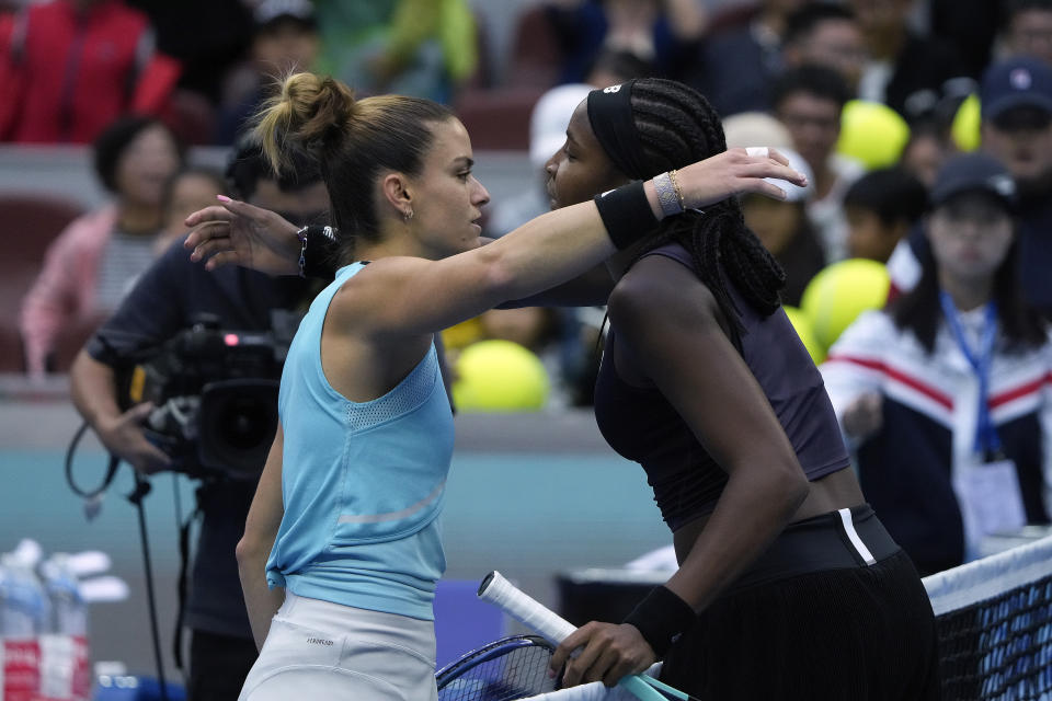 Coco Gauff of the United States, right, hugs with Maria Sakkari of Greece after beating her in the women's singles quarterfinal match of the China Open tennis tournament at the Diamond Court in Beijing, Friday, Oct. 6, 2023. (AP Photo/Andy Wong)