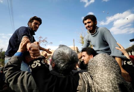 Sweets are thrown in the air for celebration to welcome hostages who escaped from their Islamic State captors in Qaryatayn town in Homs province, Syria October 29, 2017. REUTERS/Omar Sanadiki